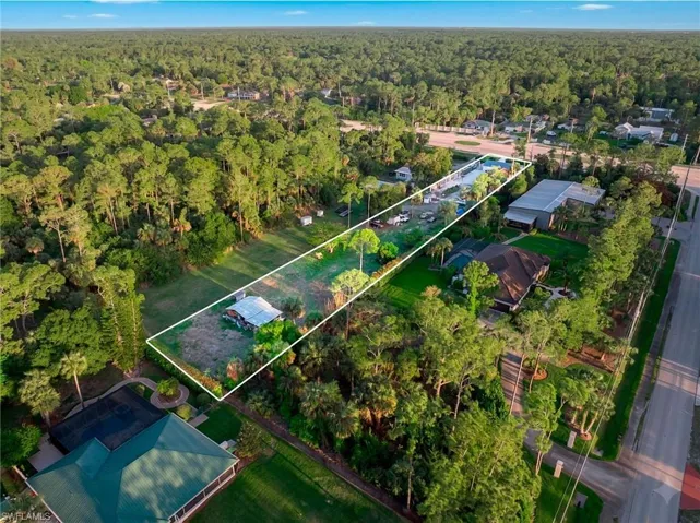 Aerial overview of property's location featuring a heavily wooded area and property boundaries highlighted