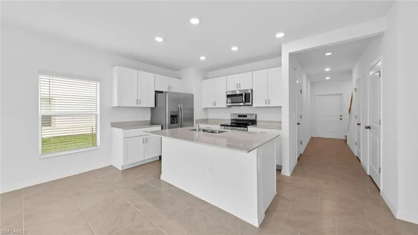 Open kitchen with contemporary cabinetry and generous counter space