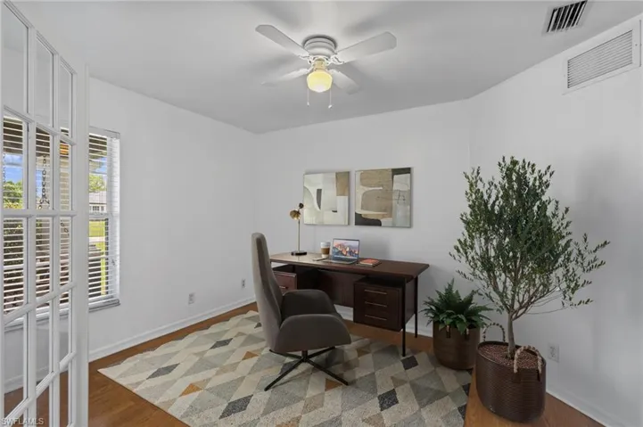 Virtually Staged! Home office with wood finished floors and ceiling fan
