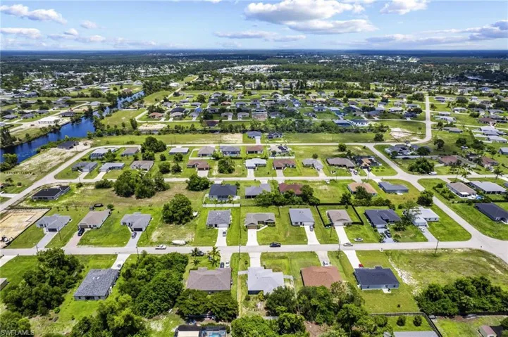 View of property location with a nearby body of water and nearby suburban area