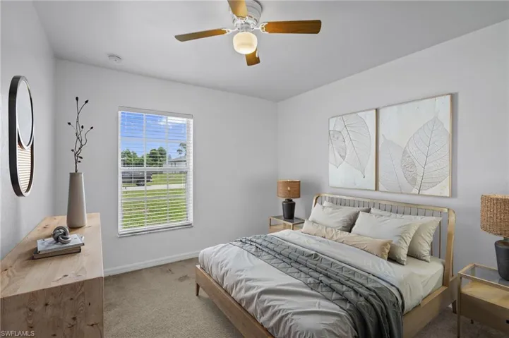 Virtually Staged! Carpeted bedroom with baseboards and a ceiling fan