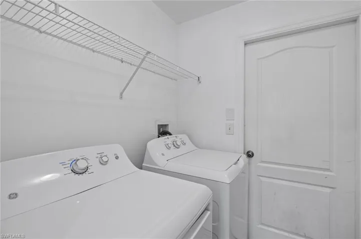 Laundry room with washing machine and clothes dryer