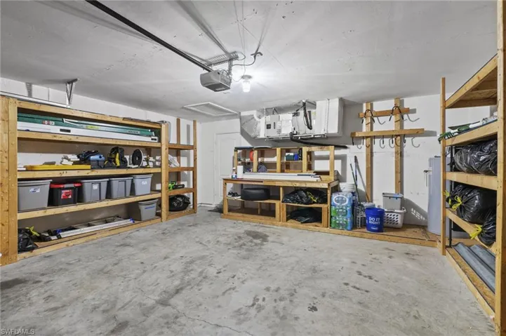 Garage with a workshop area and a garage door opener