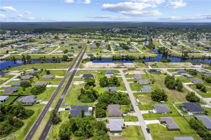 Aerial view of property's location featuring nearby suburban area and a nearby body of water