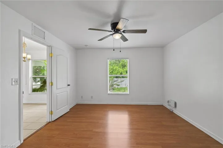 Empty room with light wood-style flooring and ceiling fan