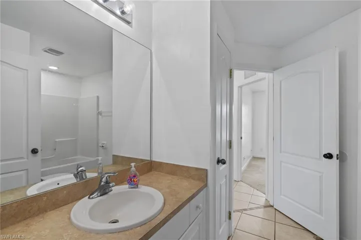 Full bath featuring tile patterned flooring and vanity