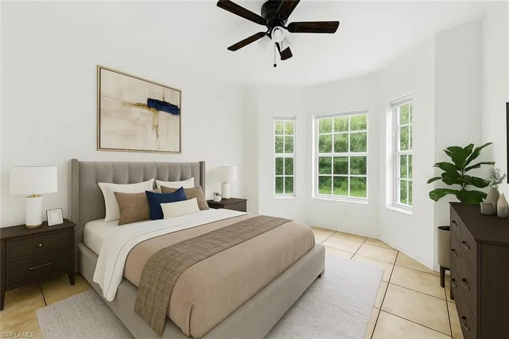 Bedroom featuring light tile patterned floors and a ceiling fan