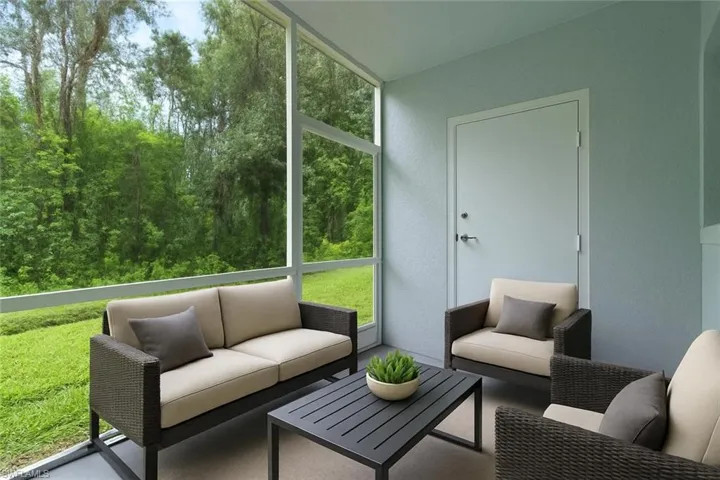 Sunroom featuring outdoor lounge area, healthy amount of natural light, and vaulted ceiling