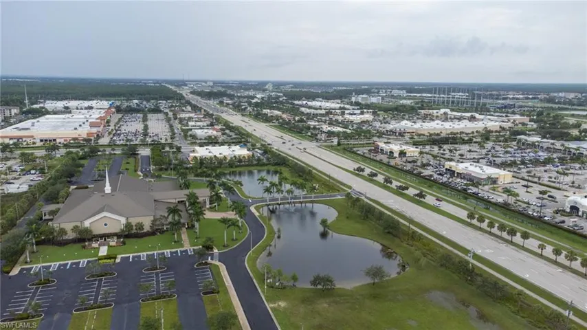 Aerial view of property's location with a main thoroughfare and a nearby body of water