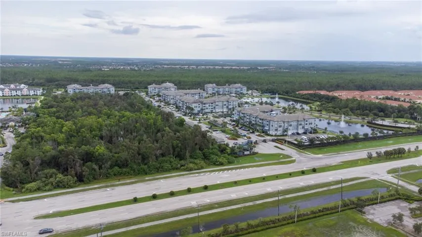 Aerial view of a heavily wooded area and a large body of water