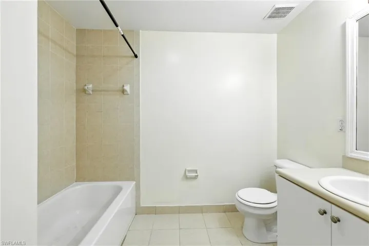 Full bath featuring tile patterned flooring, vanity, and bathtub / shower combination