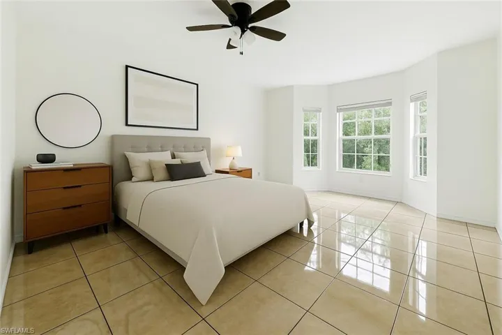 Bedroom with light tile patterned floors and ceiling fan