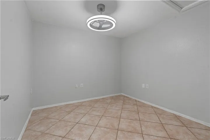 Spare room with baseboards and light tile patterned floors