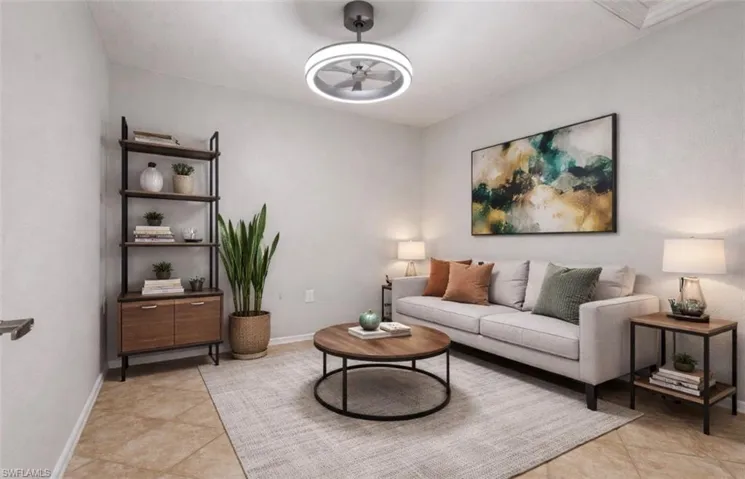 Living area with a ceiling fan and light tile patterned floors
