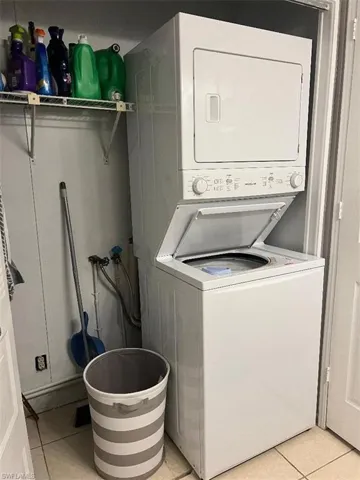 Laundry room featuring stacked washer and clothes dryer in guest bathroom