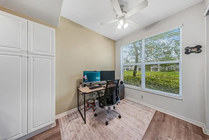 Office area featuring light wood-style floors and a ceiling fan