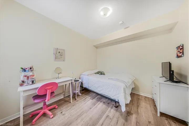 Bedroom featuring light wood finished floors and baseboards