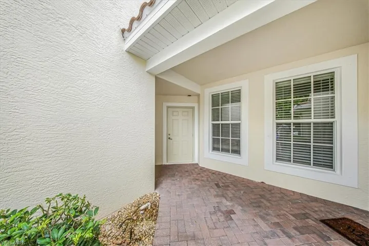 Entrance to property featuring stucco siding