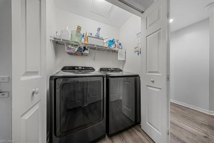 Laundry room featuring light wood-type flooring and washer and dryer