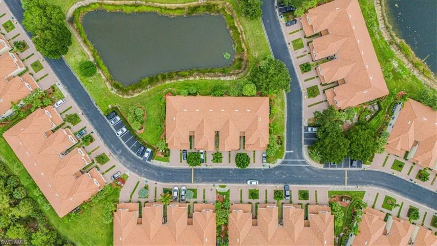 Aerial view of property and surrounding area with a nearby body of water