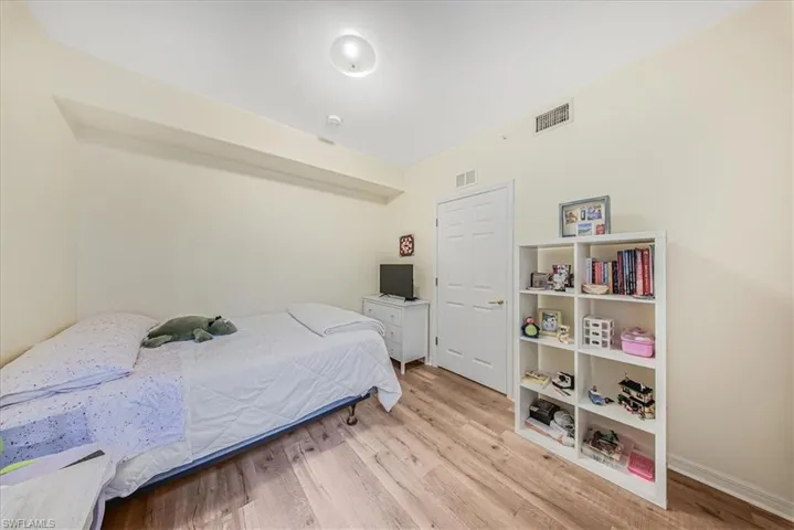 Bedroom featuring light wood-type flooring and baseboards