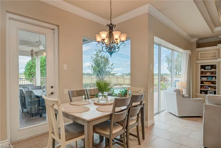 Cozy breakfast room with bullnose glass window and door overlooking the pool area.