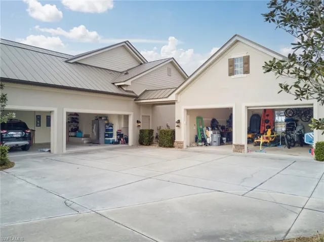Attached 2 car garage with additional 3 car garage with a connecting breezeway.  Lots of overhead attic storage in both.