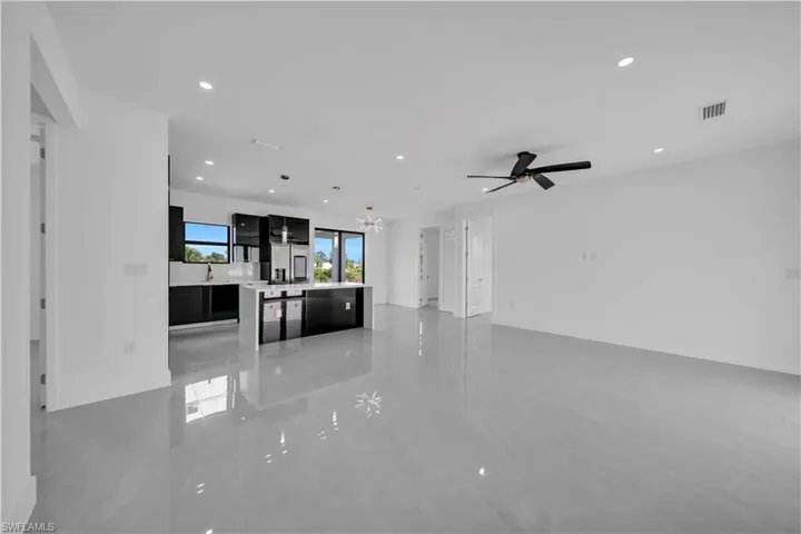 Unfurnished living room featuring recessed lighting and a ceiling fan