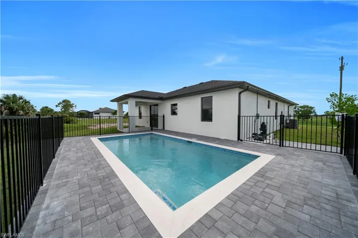 View of swimming pool featuring patio surround