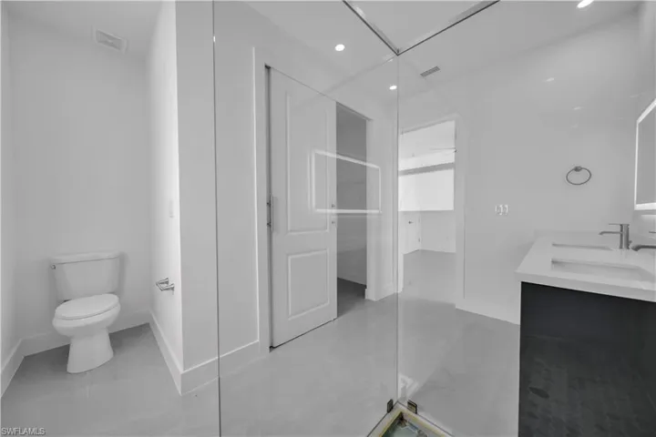 Full bath with double vanity and recessed lighting