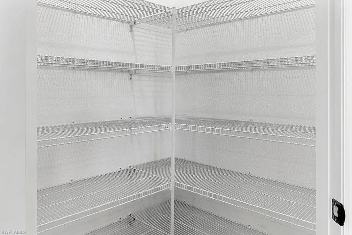 Corner pantry featuring white wire shelving