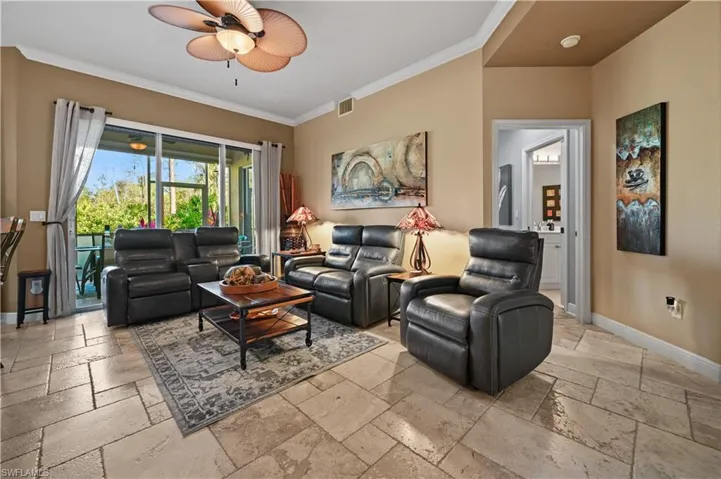 Family room with ceiling fan and crown molding