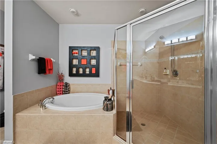 Primary Bathroom featuring shower with separate bathtub
