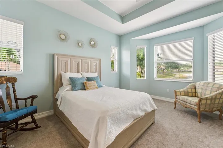 Bedroom with multiple windows and carpet floors