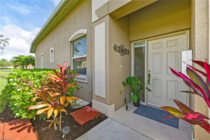 View of exterior entry featuring stucco siding