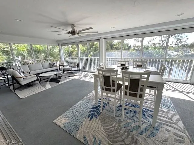 Sunroom / solarium featuring carpet floors
