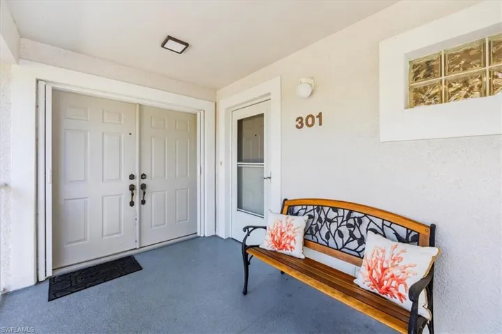 Entrance to property featuring covered porch
