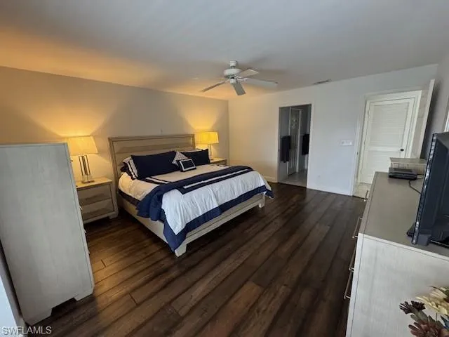 Bedroom featuring ceiling fan and dark wood-style floors