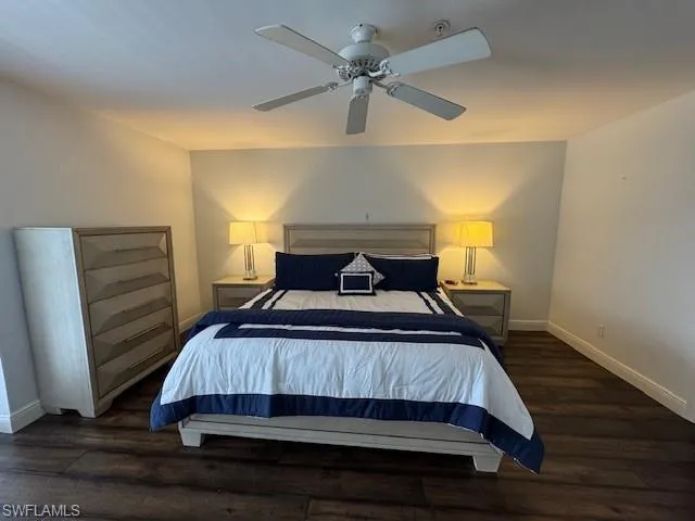 Bedroom featuring a ceiling fan and dark wood-type flooring