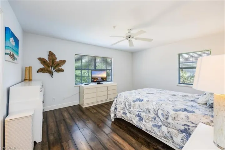 Bedroom featuring dark hardwood / wood-style floors and ceiling fan