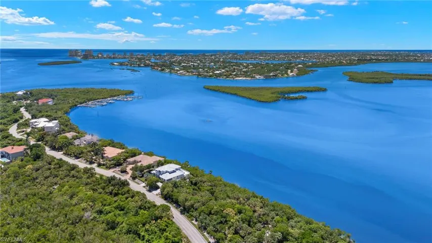 Birds eye view of property with a water view