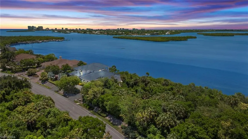 Aerial view at dusk featuring a water view