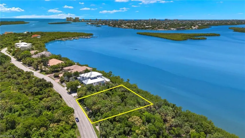Birds eye view of property with a water view