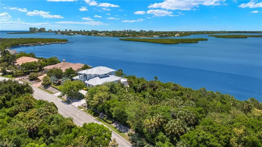 Birds eye view of property with a water view