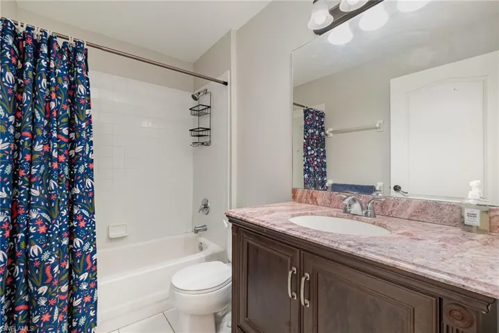 Bathroom featuring vanity and shower / tub combo