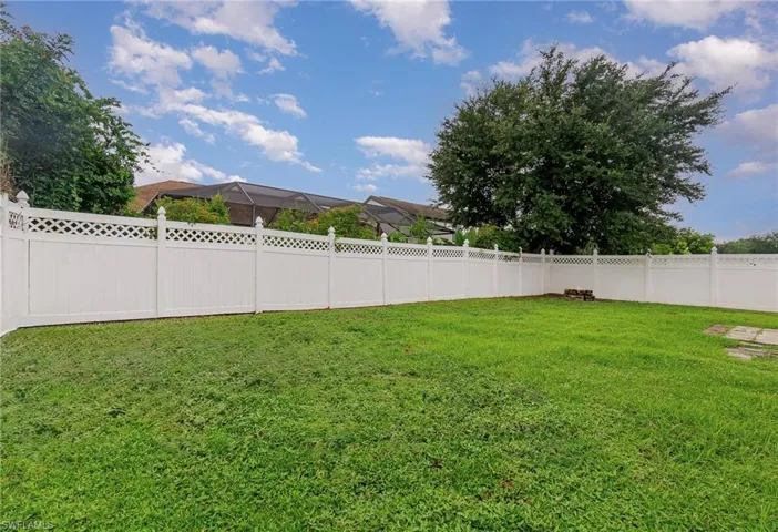 View of fenced backyard
