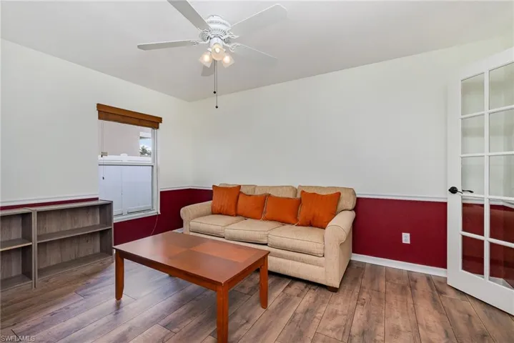 Living room featuring wood finished floors and a ceiling fan