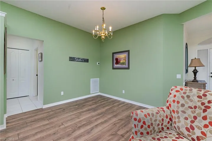 Living area featuring wood finished floors and a chandelier