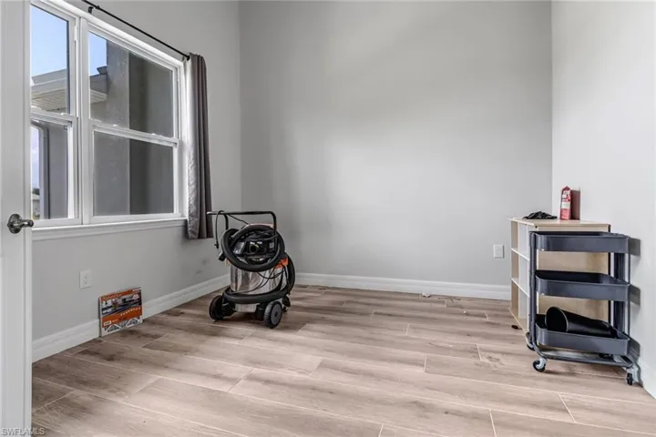 Workout area with light wood-type flooring