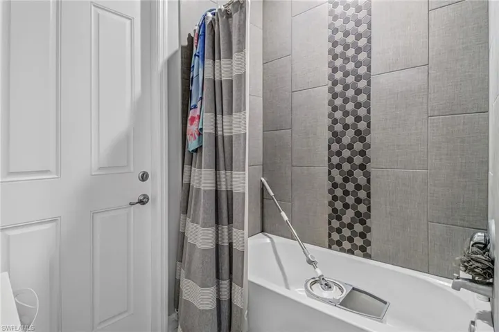 Bathroom featuring shower / bath combination with curtain